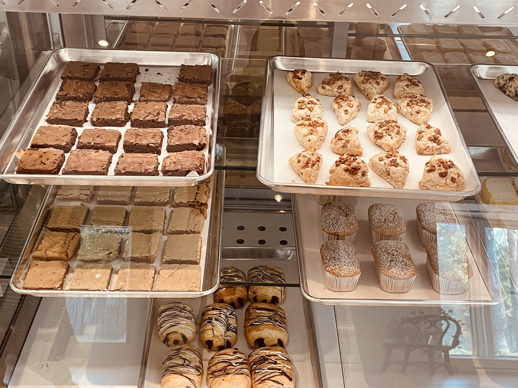 Bakery display case with brownies, cookies, scones and pastries