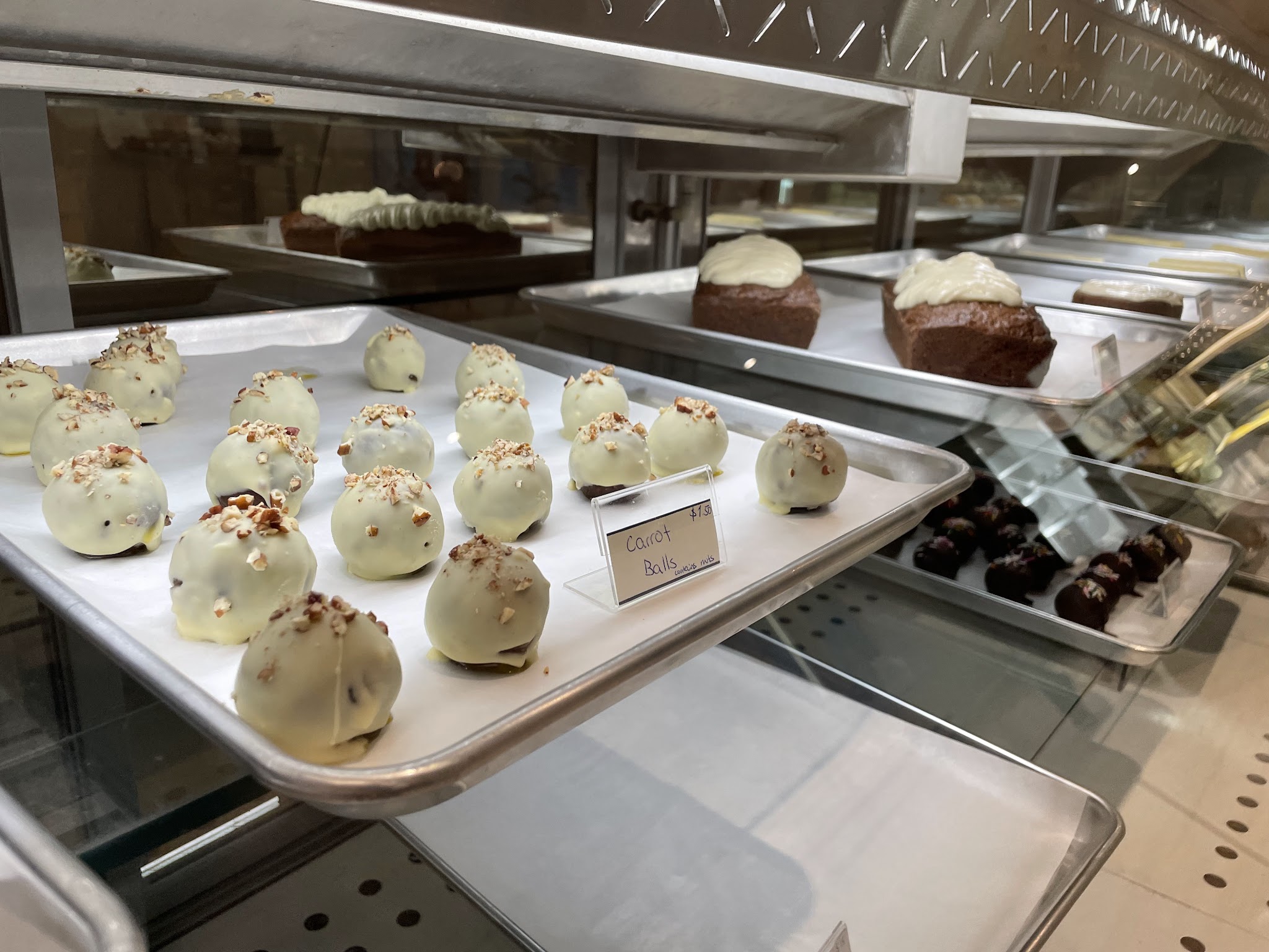 White chocolate truffles and pastries in the display case
