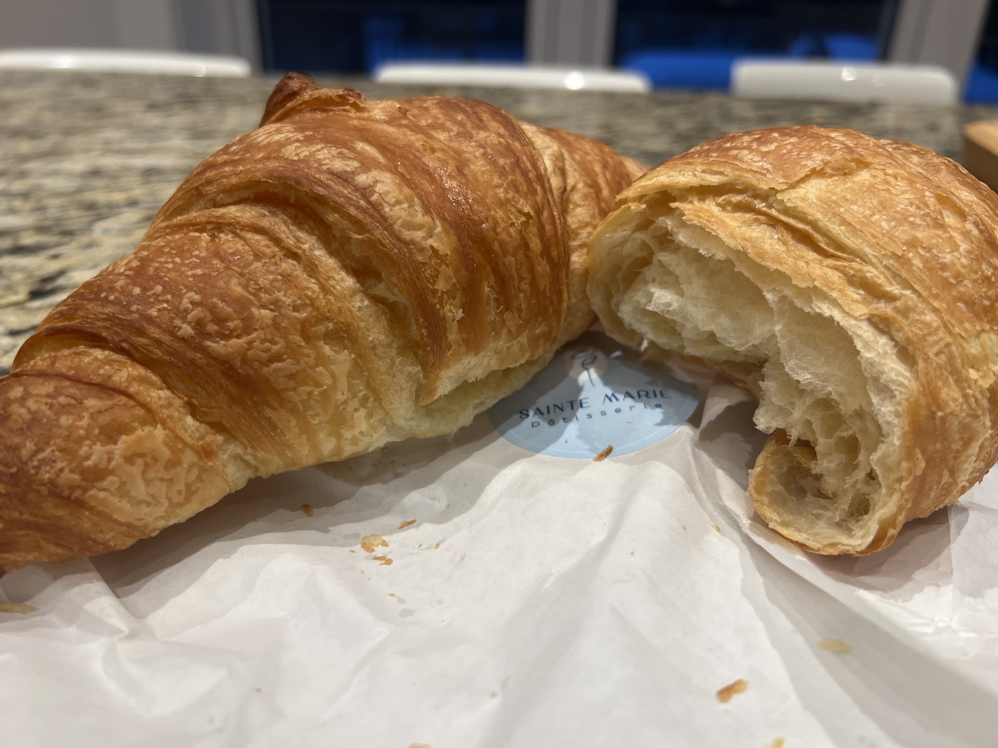 Freshly baked croissant with flaky golden layers from Sainte Marie Pâtisserie